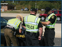 Photo of three police officers wearing safety vests