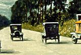 several automobiles on a two-lane road