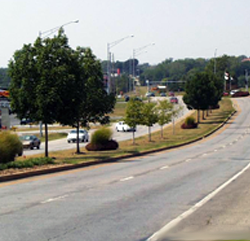 "Divided highway with a median strip showing traffic going in opposite directions."