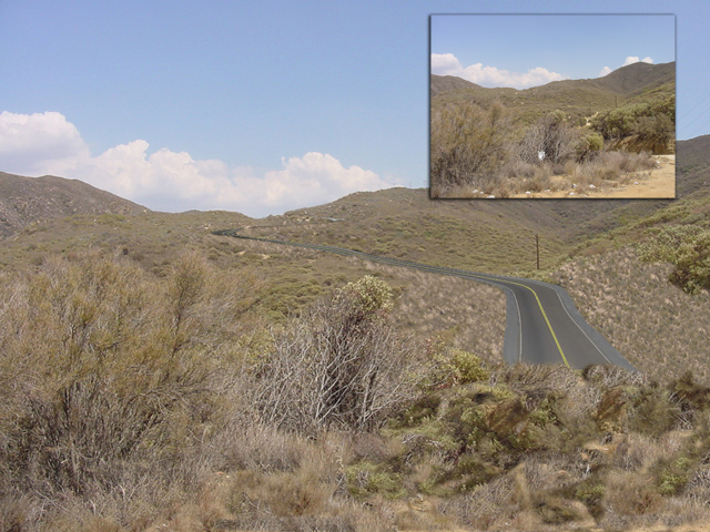 An image of a field with a digitally added road.