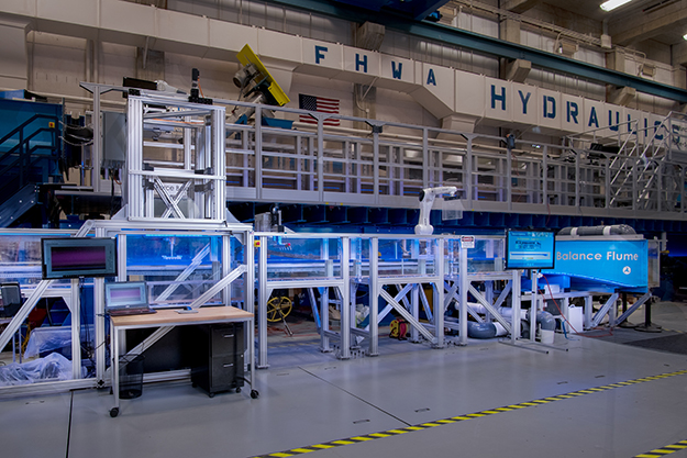 "A sideways view of the Force Balance Flume with the force balance tower on the left hand side."