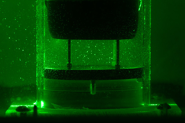 "a close-up view of the cross-section of the ISTD flow illuminated by the laser. Tracer particles are reflect the laser light and are visible in the flow."