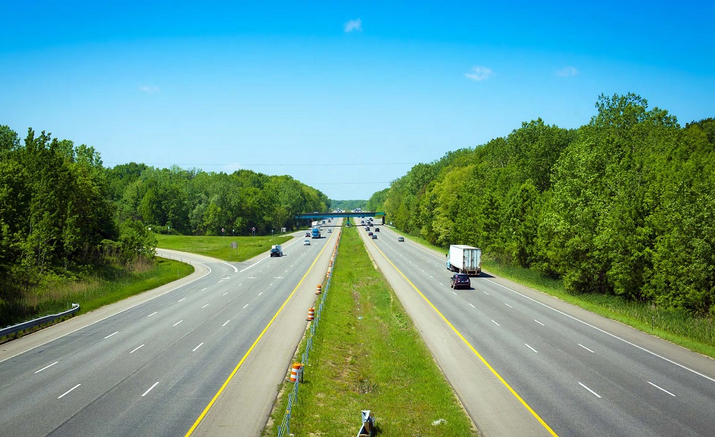 "photo from Unit 5 of the Road Safety Fundamentals report of six-lane highway surrounded by trees"