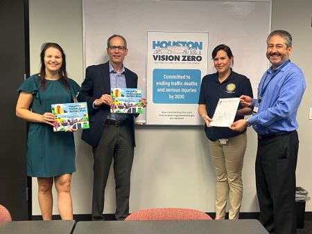 Group of four staff members from the City of Houston and City of Bellevue standing in front of signed read “Houston Vision Zero”