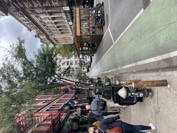 Urban street with bike lane, parking, and outdoor seating