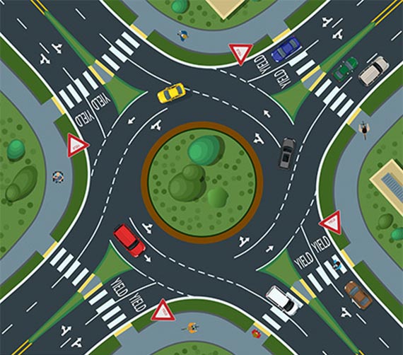 "A multilane roundabout with four approach legs. Each approach leg is a four-lane divided highway. Each approach leg yields to circulating traffic within the roundabout and features a high visibility crosswalk. Several pedestrian safety countermeasures are visible, including tactile curb ramps and multiuse path facilities."