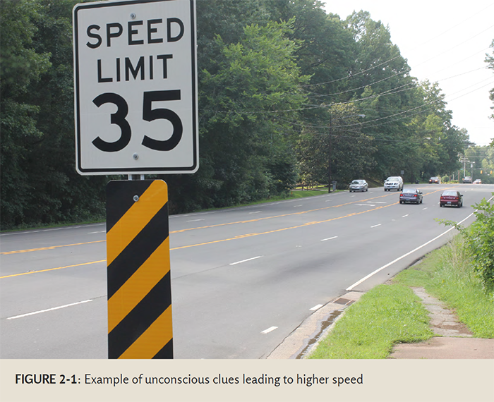 "Photo of a road with a speed limit 35 sign - The intended speed of this road is 35 miles per hour, but the wide design of the road and the number of lanes leads drivers to drive much faster."