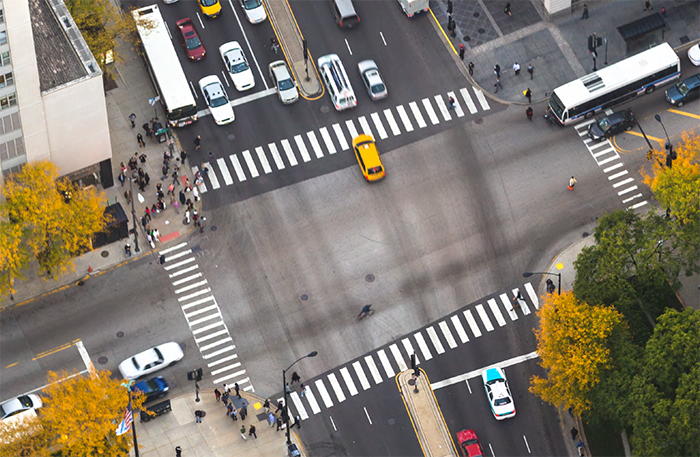 "aerial view of intersection on a four way street"