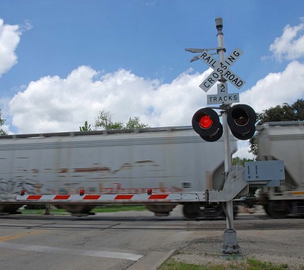 "a train traveling across a railroad crossing"