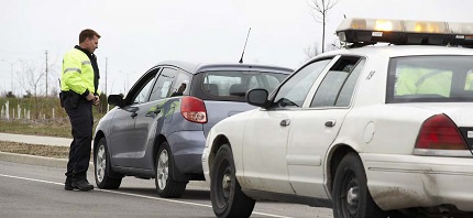 "a state highway patrolman talking to a driver he has pulled over"