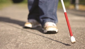 "photo of a cane being used by a visually-impaired person"