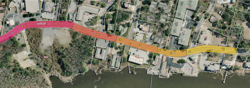 "Graphic.  An aerial photograph of the study area.  The roadway is color-coded and split into six section with each section having a different color.  Roadway section four is circled and Table 1 below includes the data for this section."
