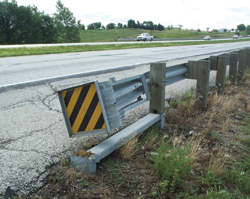 Photo. This photo shows an end treatment that is on a rail with a broken first post.