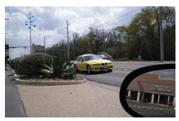 "Photo of a median that is so overgrown that approaching vehicles beyond the intersection cannot be seen by right-turning traffic."