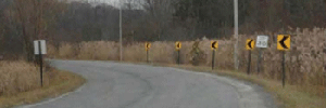 Photo of a horizontal curved road with modified size and placement of chevrons.