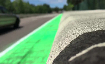 Photograph of a painted temporary green bike lane.