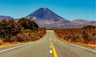 Photo of Typical rural road in New Zealand leading off into the distance towards a mountain.