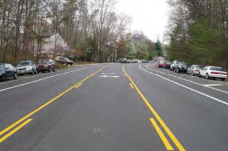 Photo shows a crosswalk on a raised section of asphalt.