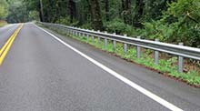 Photo of barriers installed along side of road which would keep vehicles from leaving the roadway.