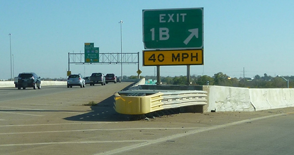 Figure 3.  Photo.  Example of a crash cushion.  This photo shows a crash cushion installed at Exit Ramp 1B. A speed warning sign denotes the ramp is 40 miles per hour.