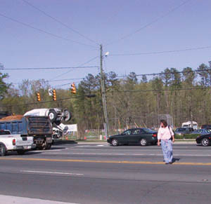 Woman crossing street, not at the intersection