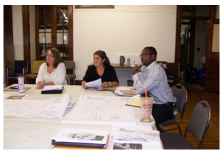 Photo of peers preparing for a peer exchange in a conference room.