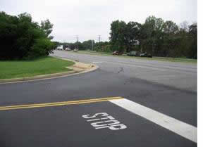 Sight distance is limited by roadside vegetation at the south access point to the post office.