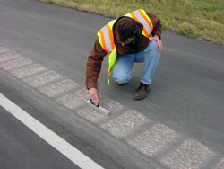 Photo (one of two) of Agency staff inspecting pavement.