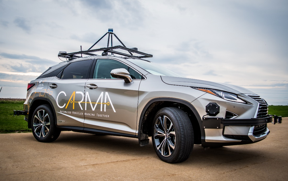 "Photo of a CARMA field research vehicle - a four door hatchback with an instrument rig on the roof and the CARMA logo painted on the doors.""