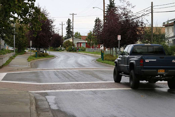 Figure 3.5.3. Chicane between Intersections.  This figure contains a photograph of a truck waiting at an intersection which is followed by a chicane curving to the right before it reaches another intersection.