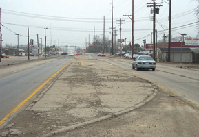 ​​The photo shows Dirksen Parkway looking south toward the intersection with Clear Lake Avenue.  The roadway is a two-lane divided highway with channelized left turn lanes and commercial land uses on both sides.