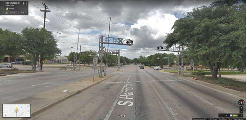 "Figure 39. Illustrative Example Showing Use of Relocated Stop Line (Dallas Rapid Transit Red Line S. Hampton Rd Crossing at Wright Street, Dallas, TX) - This figure is a photograph shows placement of the stop line ahead of the grade crossing, in conjunction with use of STOP HERE ON RED (R10-6) and DO NOT STOP ON TRACKS (R8-8) signs."