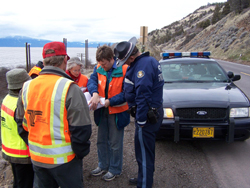 Road safety audit team reviewing plans on site at a coastal highway