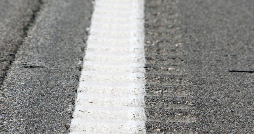 "Longitudinal rumble strips overlapping with the edge line of the roadway."