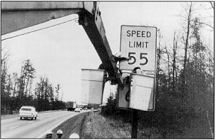 Signs go up as the speed limit comes down.