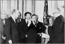 President Gerald R. Ford looks on (left) as Supreme Court Justice Thurgood Marshall administers oath of Office to Secretary William T. Coleman, Jr.