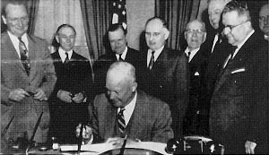 President Dwight D. Eisenhower signs the Federal-Aid Highway Act of 1954- The White House ceremony is attended by Members of Congress who were instrumental in passage of the measure. From left to right: Senator William F. Knowland (CA), Senate Majority Leader; Representative George A. Dondero (MI), Chairman, House Public Works Committee; Representative Clifford Davis (TN), member, House Public Works Committee; Senator Francis Case (SD), Chairman, Senate Subcommittee on Roads; Representative Homer D. Angell (OR), member, House Public Works Committee; Senator Edward Martin (PA), Chairman, Senate Public Works Committee; Representative J. Harry McGregor (OH) Chairman, House Subcommittee on Roads; and Representative George H. Fallon (MD), ranking minority member, House Subcommittee on Roads.
