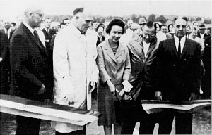 Alabamans celebrate National Highway Week with this ribbon cutting ceremony on 1-65 between Montgomery and Birmingham. Left to right: Chief Engineer R. D. Jordan, Alabama Highway Department (AHD); AHD Director Sam Engelhardt; Mrs. Morgan Reynolds (sister of Governor John Patterson's wife); Executive Assistant Walter H. Craig, AHD; and BPR Division Engineer B. A. Scott.