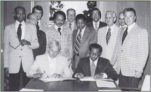 Administrator Norbert Tiemann (seated, left) and Samuel J. Cornelius, Deputy Director, Office of Minority Business Enterprise, sign memorandum of understanding to increase participation of minority business enterprises in Federal-aid highway projects.