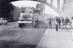 September 7 1950	President Harry Truman signs the Federal-Aid Highway Act, which requires State highway departments to hold public hearings for all projects bypassing cities or towns and provides sanctions for failure to maintain Federal-aid highways properly. It also authorizes $10 million for defense access road construction to meet Korean War needs. 1981	In New York City, President Ronald Reagan delivers a giant-sized check for $85 million to Mayor Edward Koch and Lt. Governor Mario Cuomo. "People tell me," the President says, "that the name Westway has become a code word for a bureaucracy strangling in its own regulations. From this day forward, let Westway symbolize opportunity and enterprise and let it remind each of us, as we watch Westway become a reality, that our Government works for us, not the other way around." (See September 30, 1985.) 1990	Deputy Administrator Gene McCormick leads a study team of Federal, State, and industry officials who review asphalt pavement techniques in six European countries (Denmark, France, Germany, Italy, Sweden, and the United Kingdom). They return on September 22 after observing many techniques and procedures that would be useful in the United States. But they also found many differences between U.S. and European organization, philosophy, taxation levels, and practice that make other findings harder to apply. Photo: European Asphalt Study Tour team abserves paving operation in Germany. European Asphalt Study Tour team abserves paving operation in Germany.  "Our transportation network is our greatest economic asset. If we do not give it our best--and Europe's best--we will undermine our own success." Thomas D. Larson Federal Highway Administrator