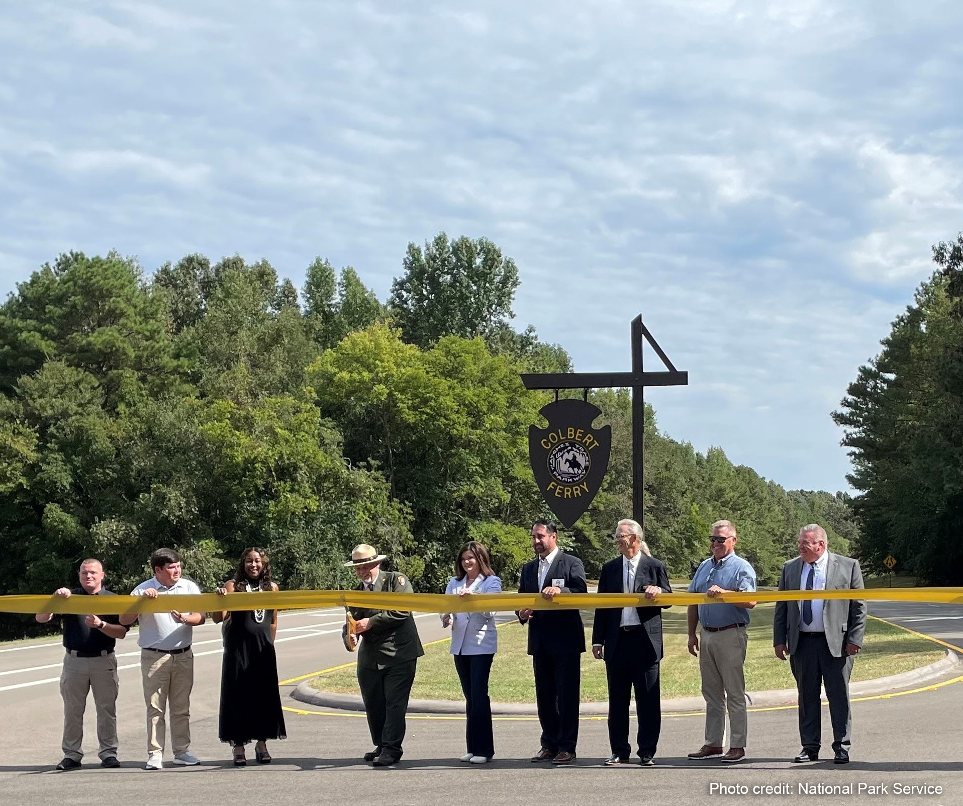 Nine officials from FHWA, NPS, Natchez Trace Parkway and surrounding communities at the ribbon cutting event.