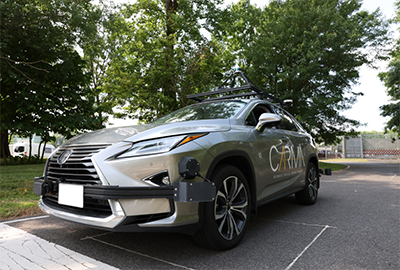 The front of a CARMA℠-branded vehicle shows equipment installed to support self-driving functionality. 