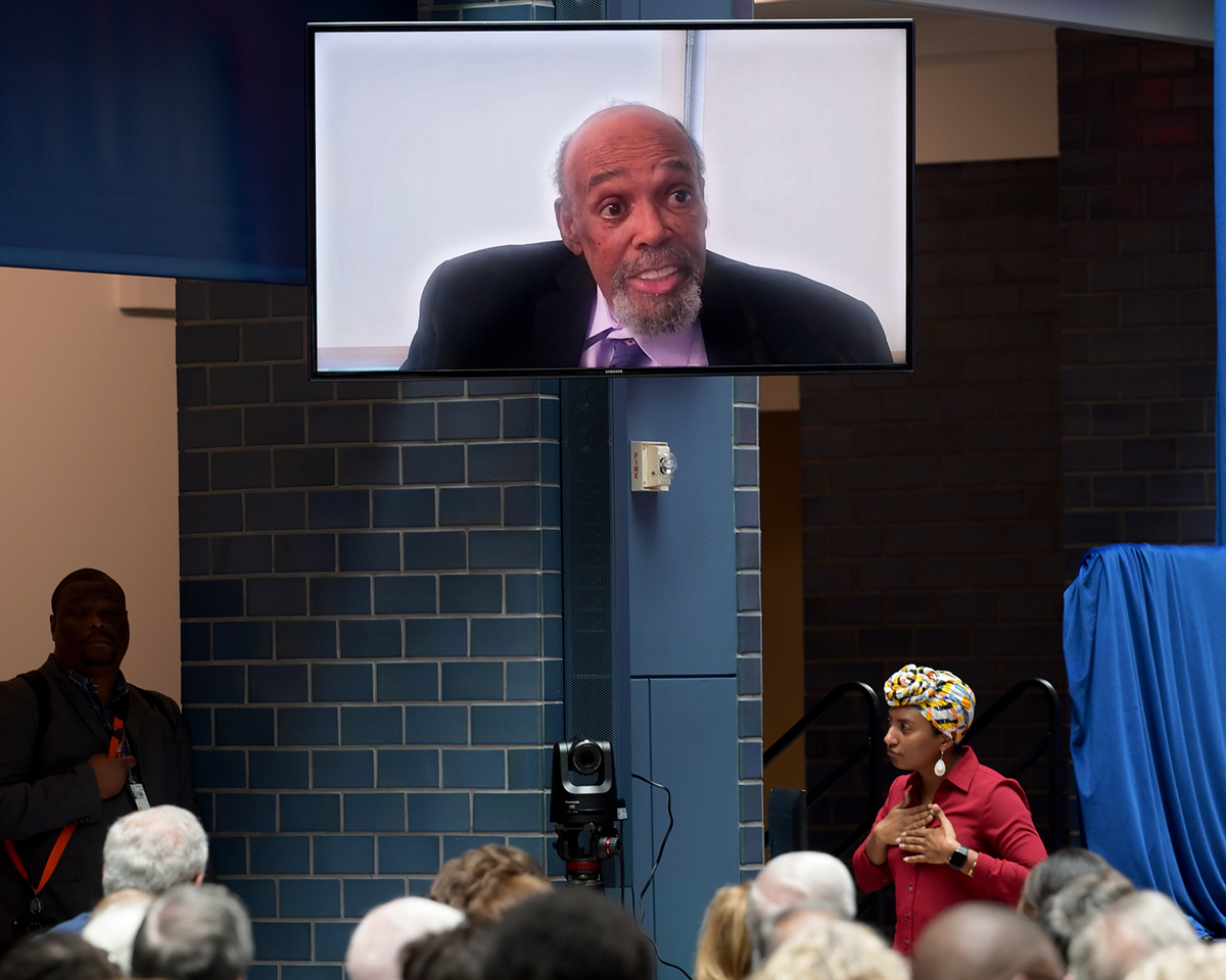 William T. Coleman III speaking via video shown to the audience.