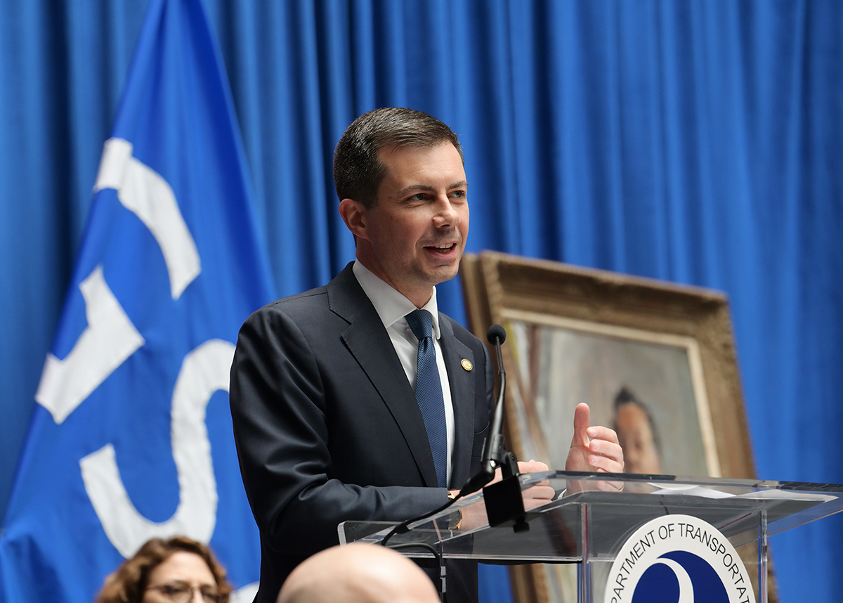 Secretary Buttigieg speaking from the podium