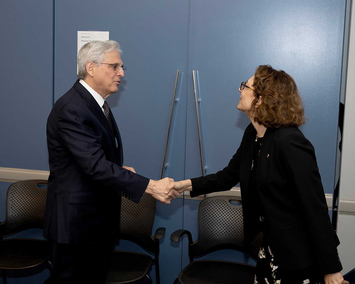 Attorney General Merrick B. Garland shaking hands with Deputy Secretary Polly Trottenberg