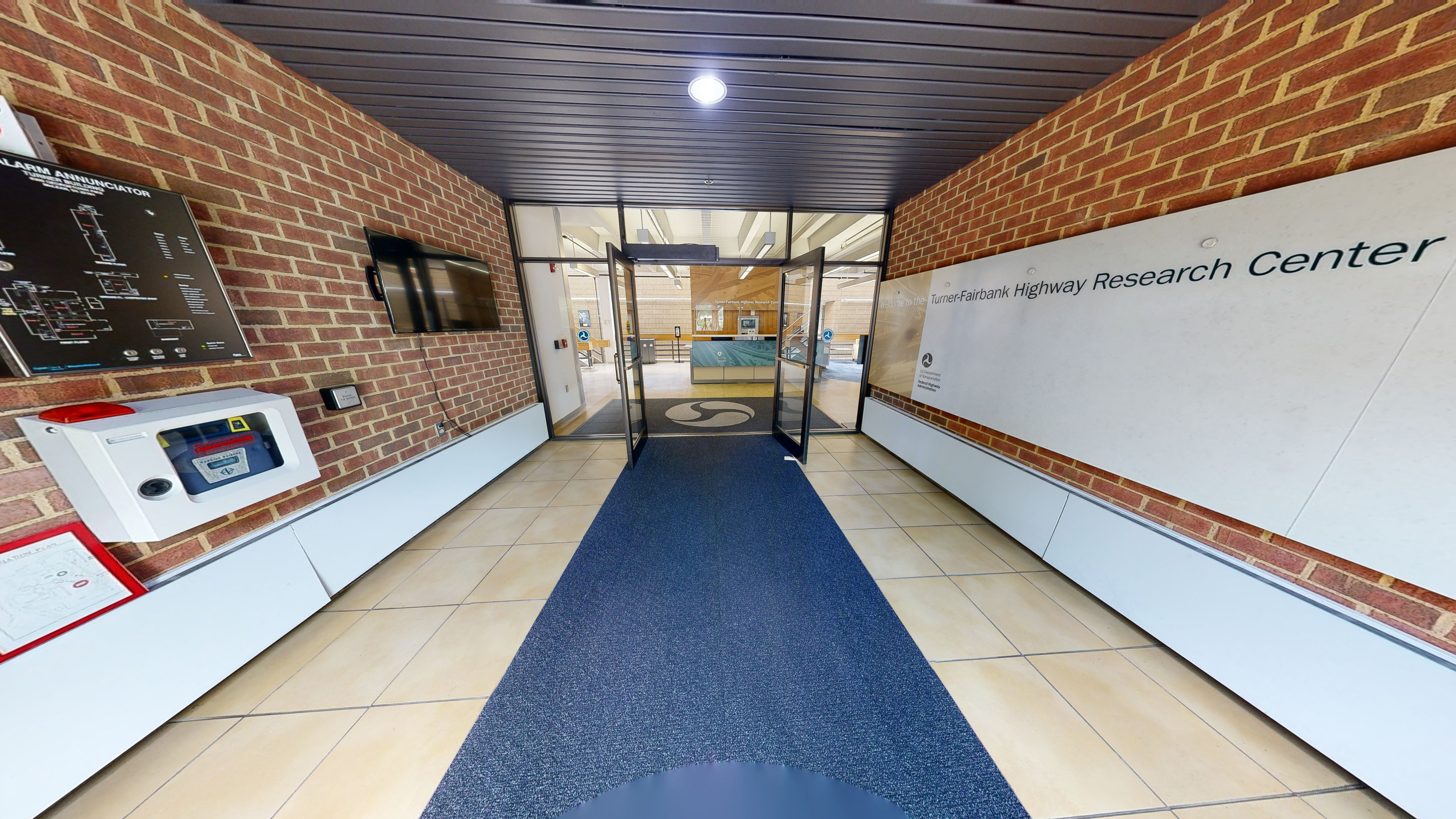 An entry vestibule features a welcome sign on the right-hand side.