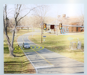 A car encircled by ripples approaches a traffic light intersection near a ray of ripples from a device, demonstrating signals being sent. 