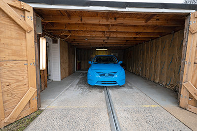 A car sits on a track in a garage.  