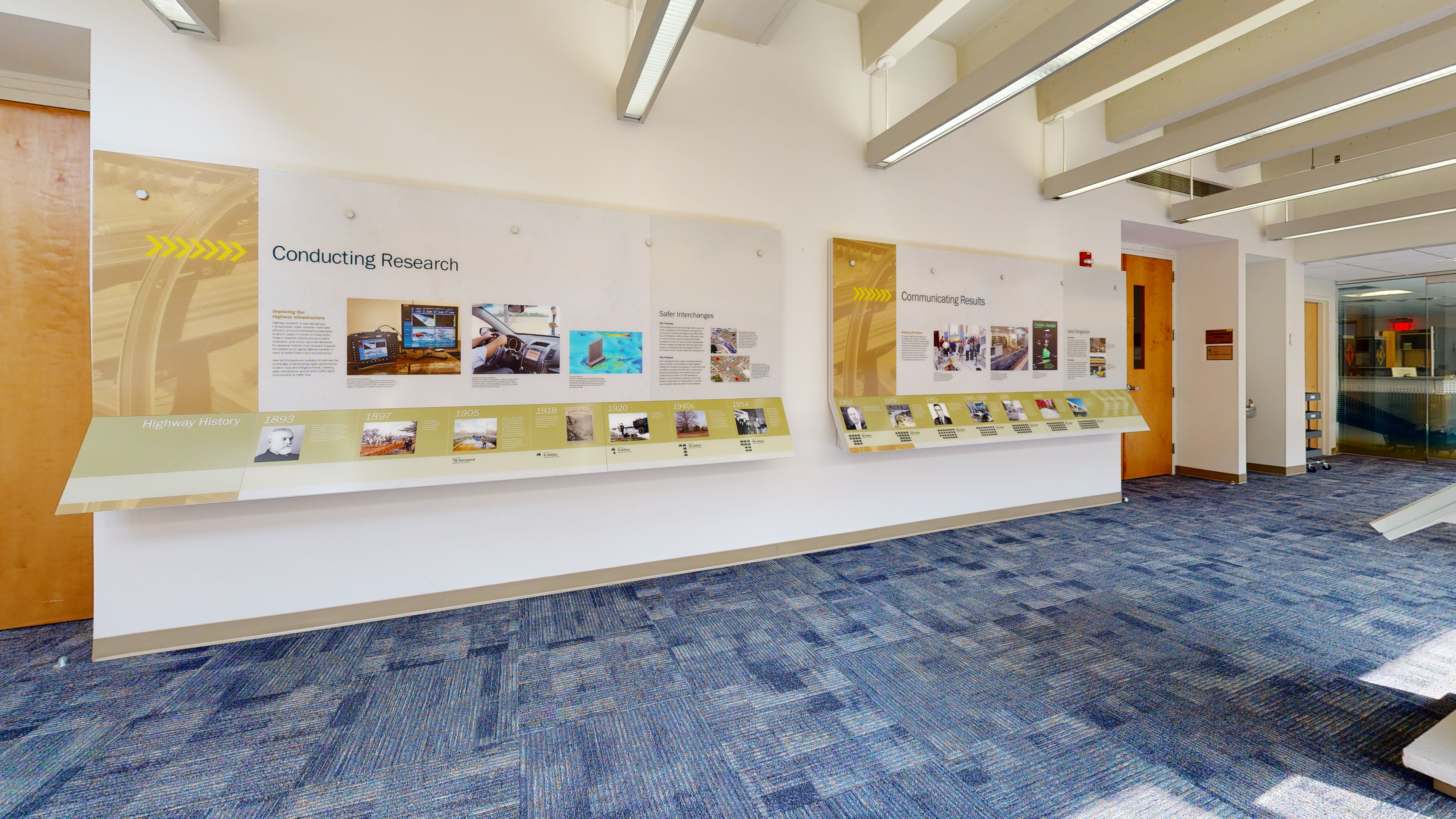 Two large informational wall panels contain photographs and text.