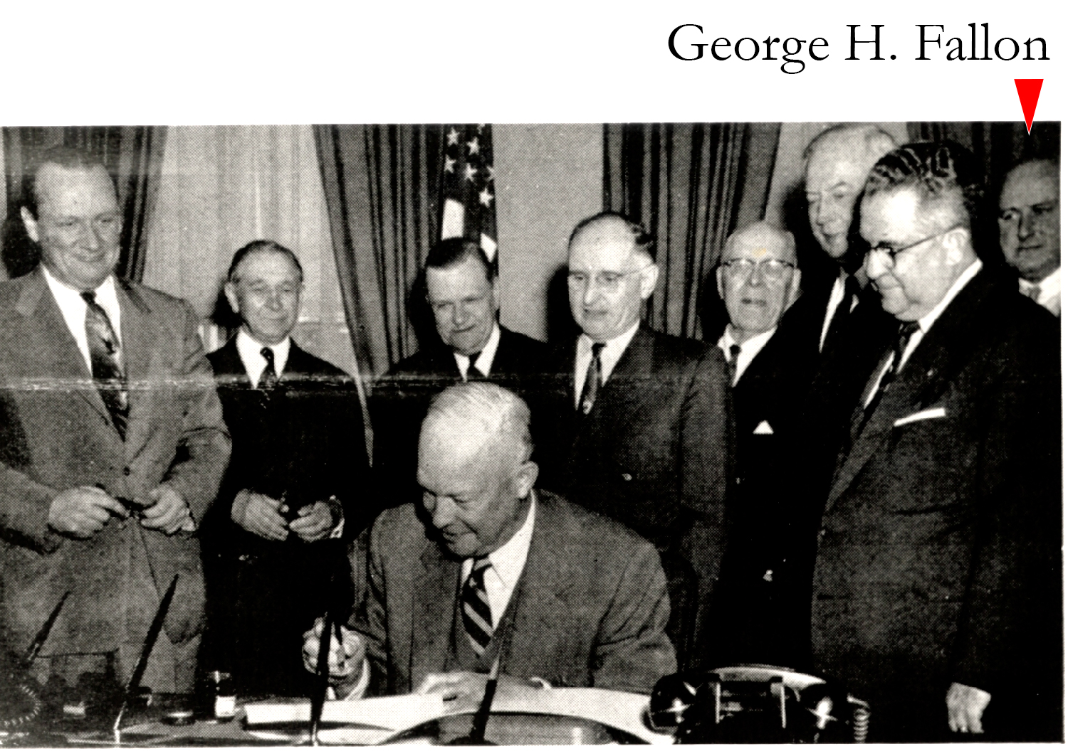 Left to right: Senator William F. Knowland, CA; Rep. George A. Dondero, MI; Rep. Clifford Davis, TN; Senator Francis Case (SD); Rep. Homer D. Angell, OR; Senator Edward Martin, PA; and Rep. J. Harry McGregor, OH. On the far right, in the back, barely in the photograph, trying to see the President, is Rep. George H. Fallon, MD, who was one of the primary authors of the 1954 Act and who would be one of the primary authors of the 1956 Act.